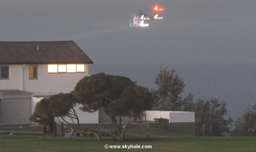 The invisible police helicopter searching for something.
It's lights gives a basic helicopter shape.
A faint search light beam is noticeable shining forward.